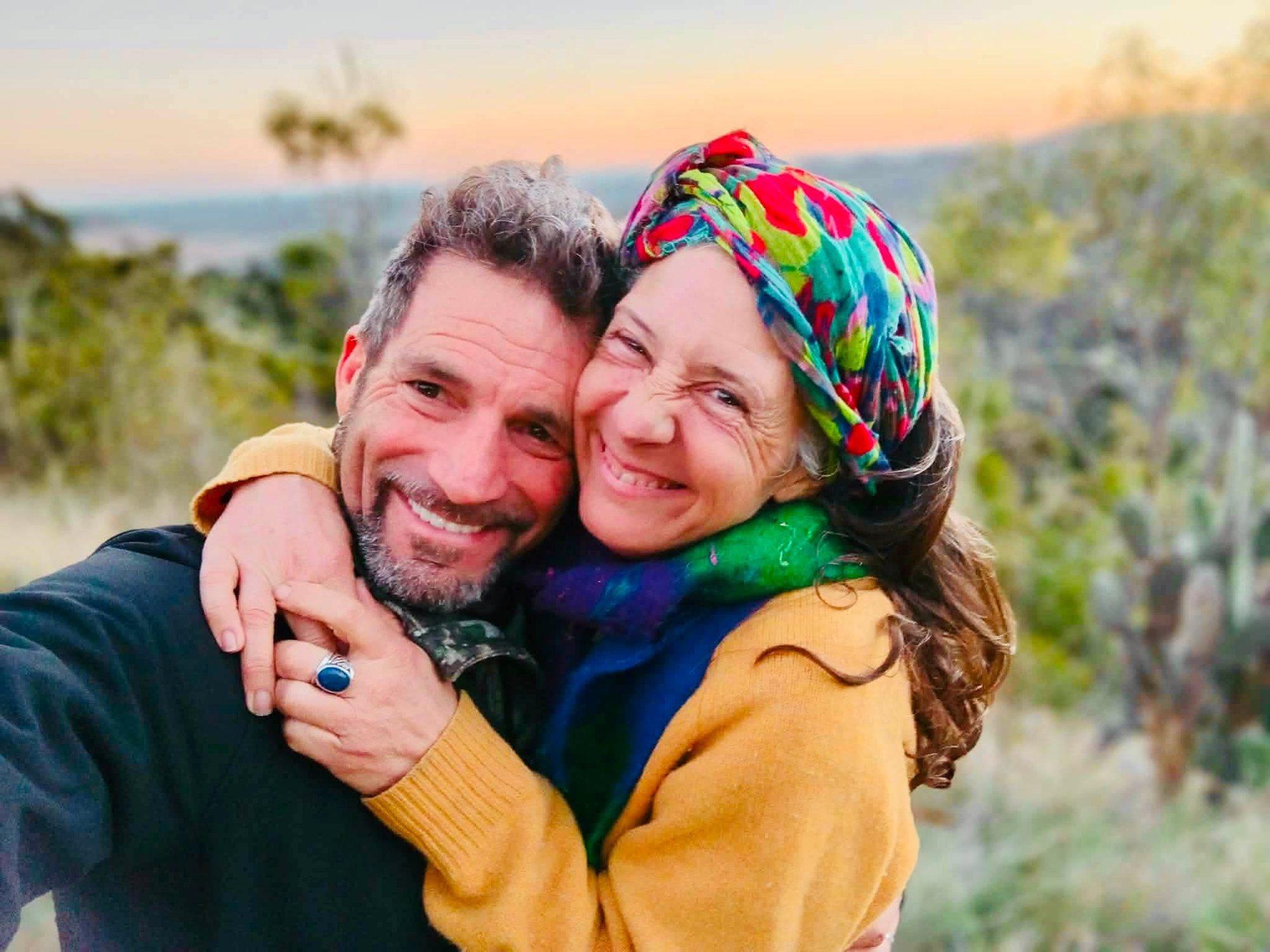 Michael and Joy embracing at sunset on the Sunshine Coast