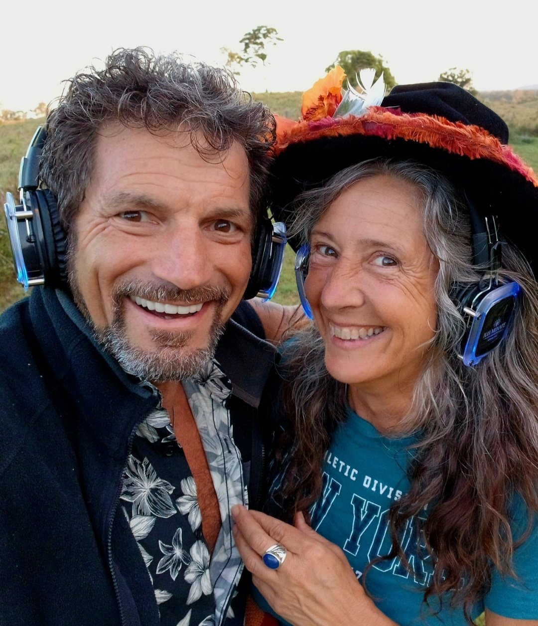 Michael and Joy laughing together wearing headphones